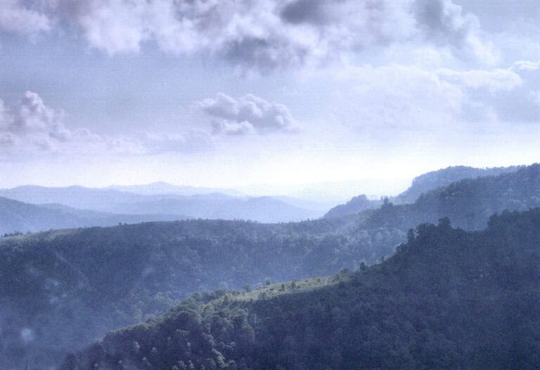 Misty ridges of the Appalachian Mountains in eastern Kentucky under a cloudy sky.