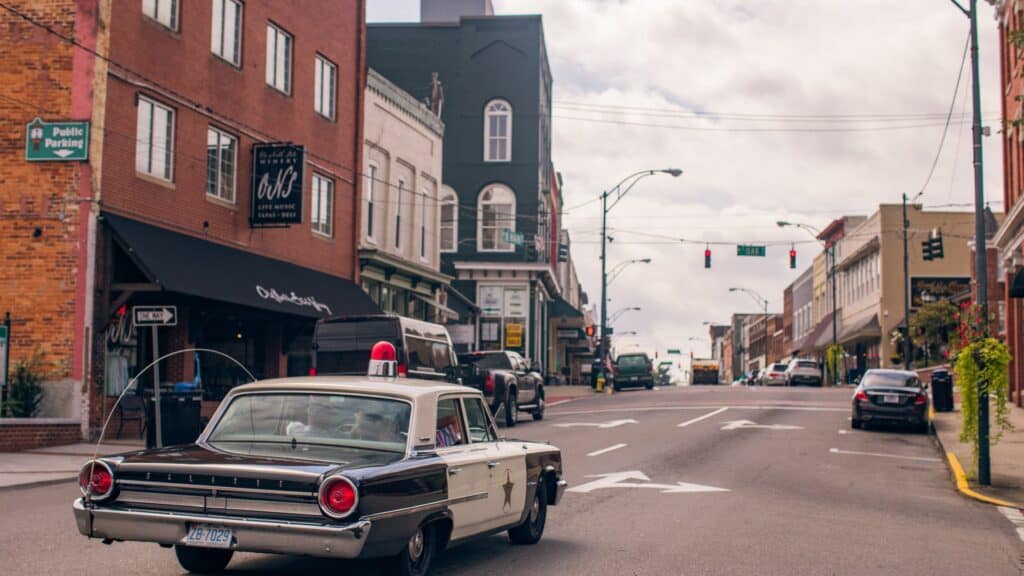 Mayberry patrol car drives through downtown Mount Airy NC, capturing the small-town spirit.