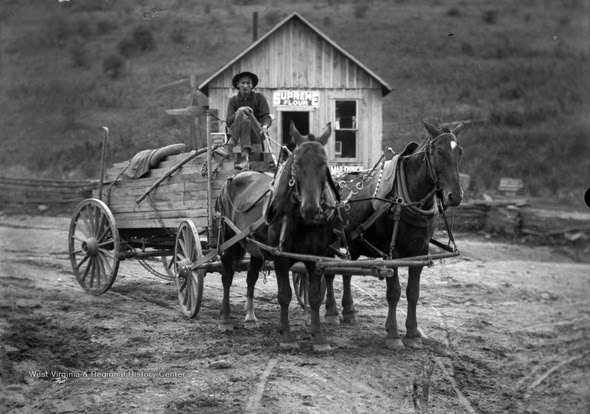 Early-1900s horse-drawn wagon outside a rural mountain store, typical of travel before the Fancy Gap Mountain highway.