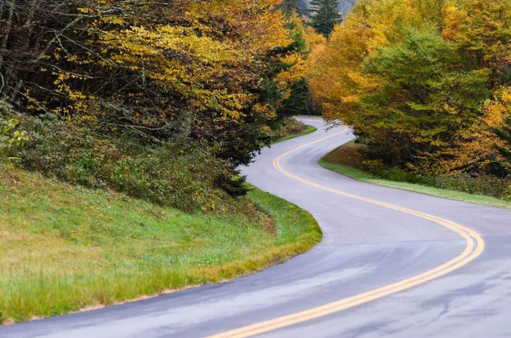 Paved Blue Ridge Parkway curving through autumn hills in Appalachia.