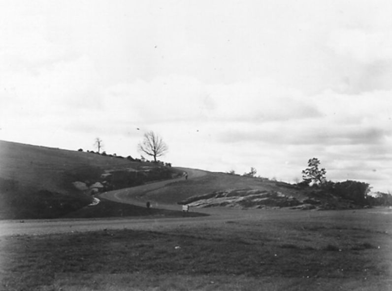Historic view of the Bluffs Lodge entry road with early grading and CCC-era site shaping.