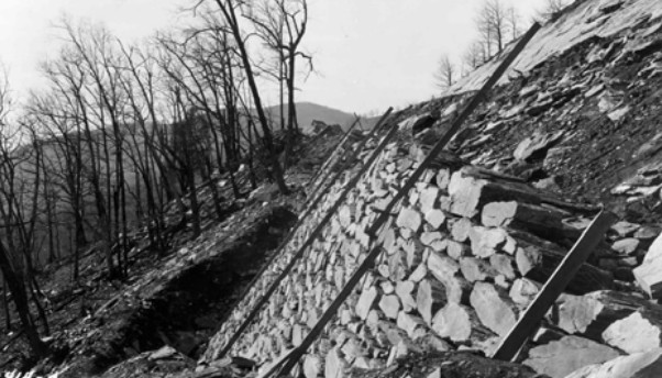 Early Blue Ridge Parkway CCC landscaping showing hand-laid stone embankment under construction.