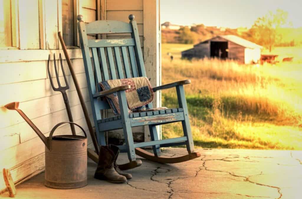 Farmhouse porch scene connected to everyday life in Appalachian family history.