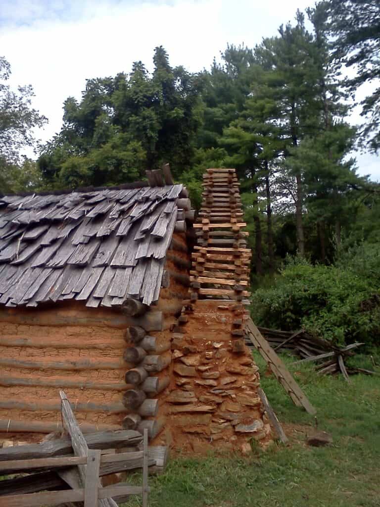Stick-and-clay version of an Appalachian cabin chimney showing a temporary structure built from simple materials.