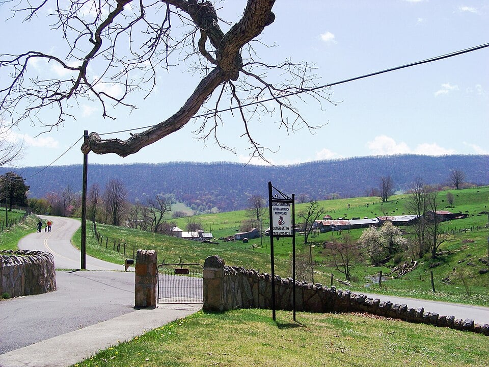 Entrance road and stone wall marking the approach into burkes garden virginia