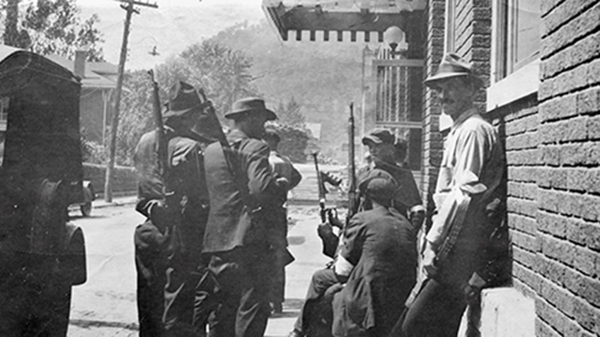 Armed guards and local men gathered during a coalfield labor dispute in Appalachia
