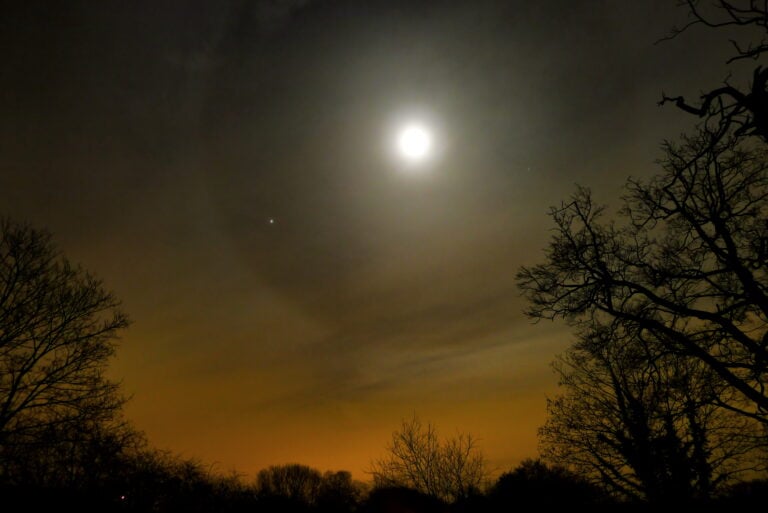 Halo around the moon signaling moisture in mountain weather signs