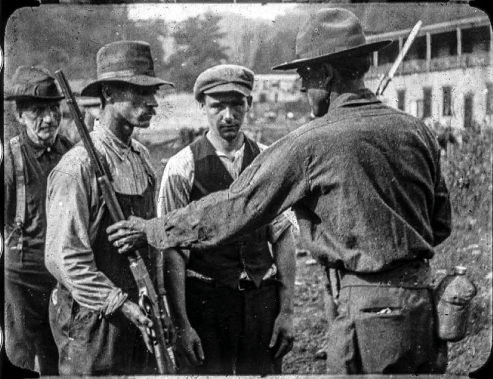 Miners surrendering rifles at the end of the Battle of Blair Mountain in 1921