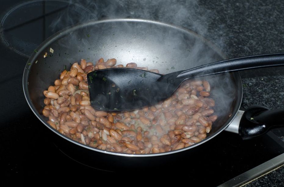 Cast iron pot filled with cooked beans, illustrating how Appalachian kitchen foraging added flavor to everyday meals.