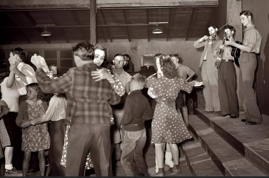 Couples dancing to a live string band during a community barn dance in Appalachia