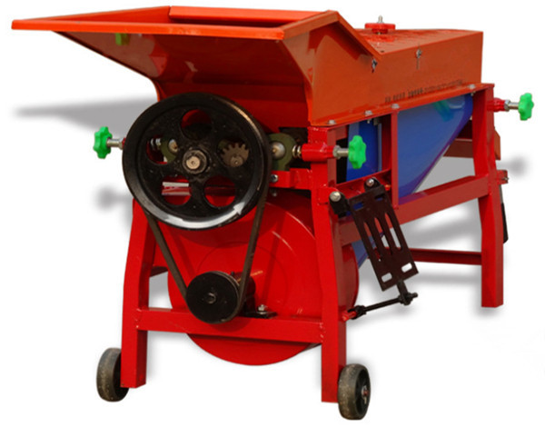 Small farm corn husker machine used to remove corn husks with mechanical rollers