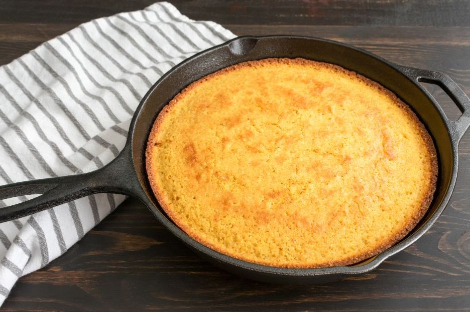 Appalachian cornbread in a cast iron skillet on a plain table