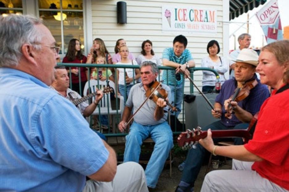 Musicians and small crowd gathered outside playing during Friday night in Floyd, Virginia