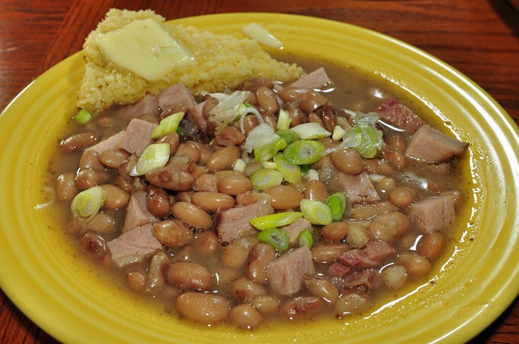Appalachian cornbread served with pinto beans in a simple bowl