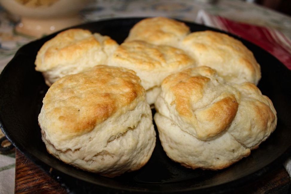 Fresh biscuits cooling in a cast iron skillet in a mountain kitchen