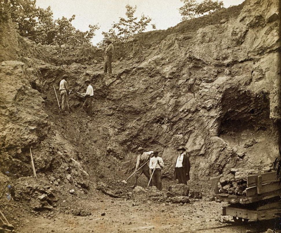 Workers digging iron ore from an Appalachian ore bank supplied nearby furnaces and charcoal hearth operations.