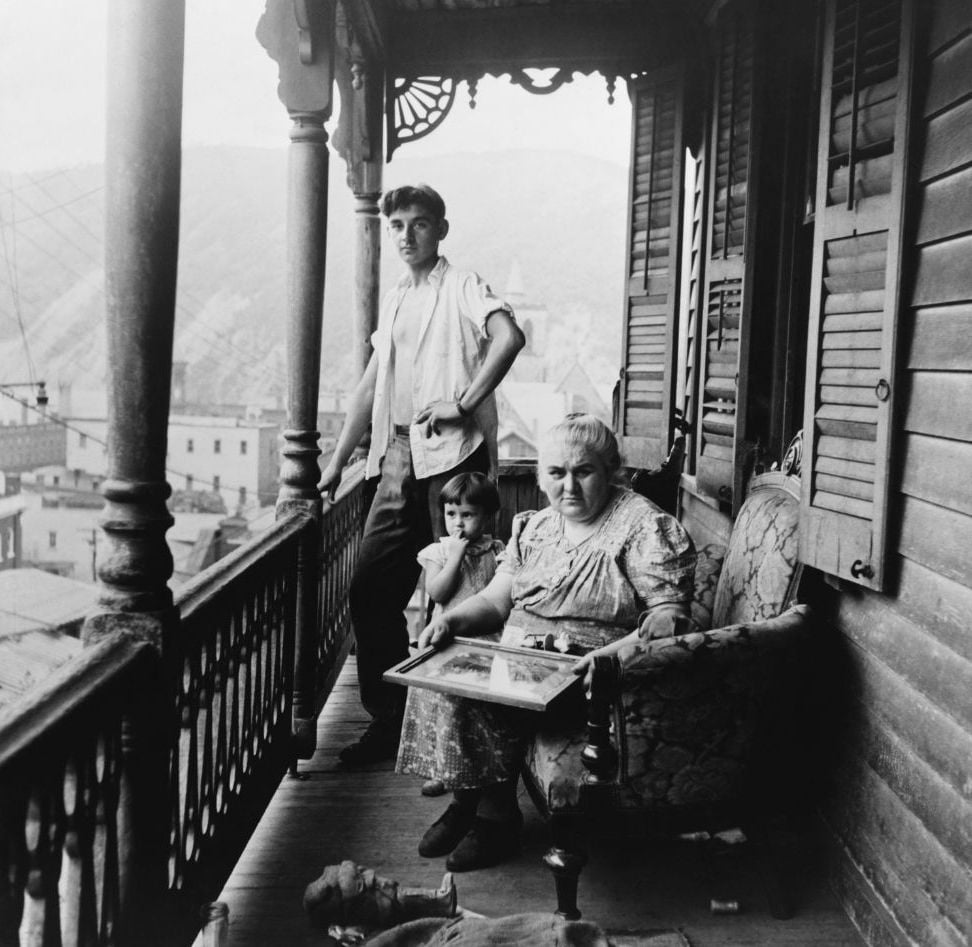 Appalachian family on a porch awaiting news from relatives