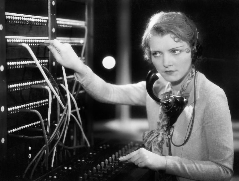 Telephone operators manually connected calls at a switchboard before direct dialing became common.