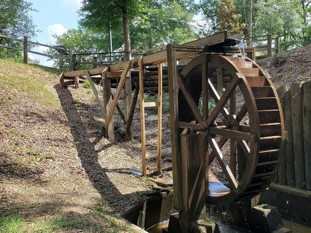 Waterwheel and sluice directing creek water to power Appalachian grist mills