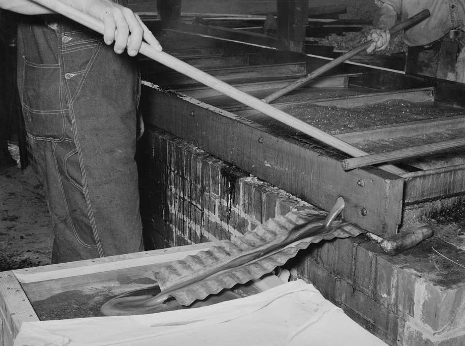 Close-up view of boiling sorghum juice in evaporation pans
