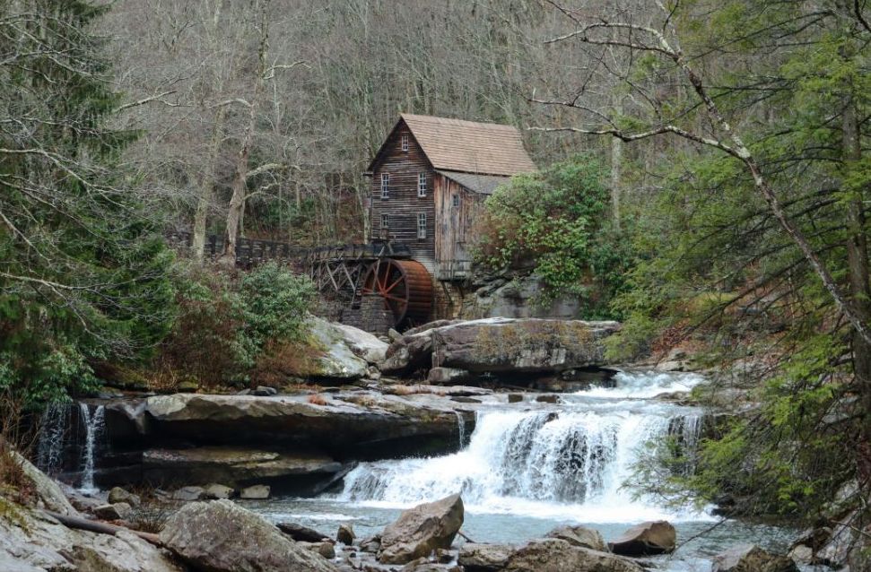Historic grist mill beside a mountain waterfall in Appalachia