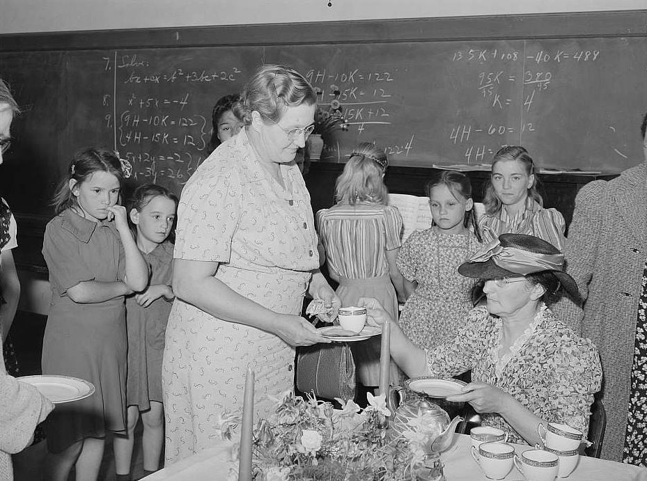 Families gather inside a school building for a community event.