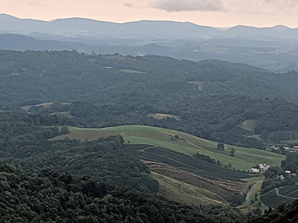 Rolling farmland and distant mountain ridges viewed from the Virginia high country