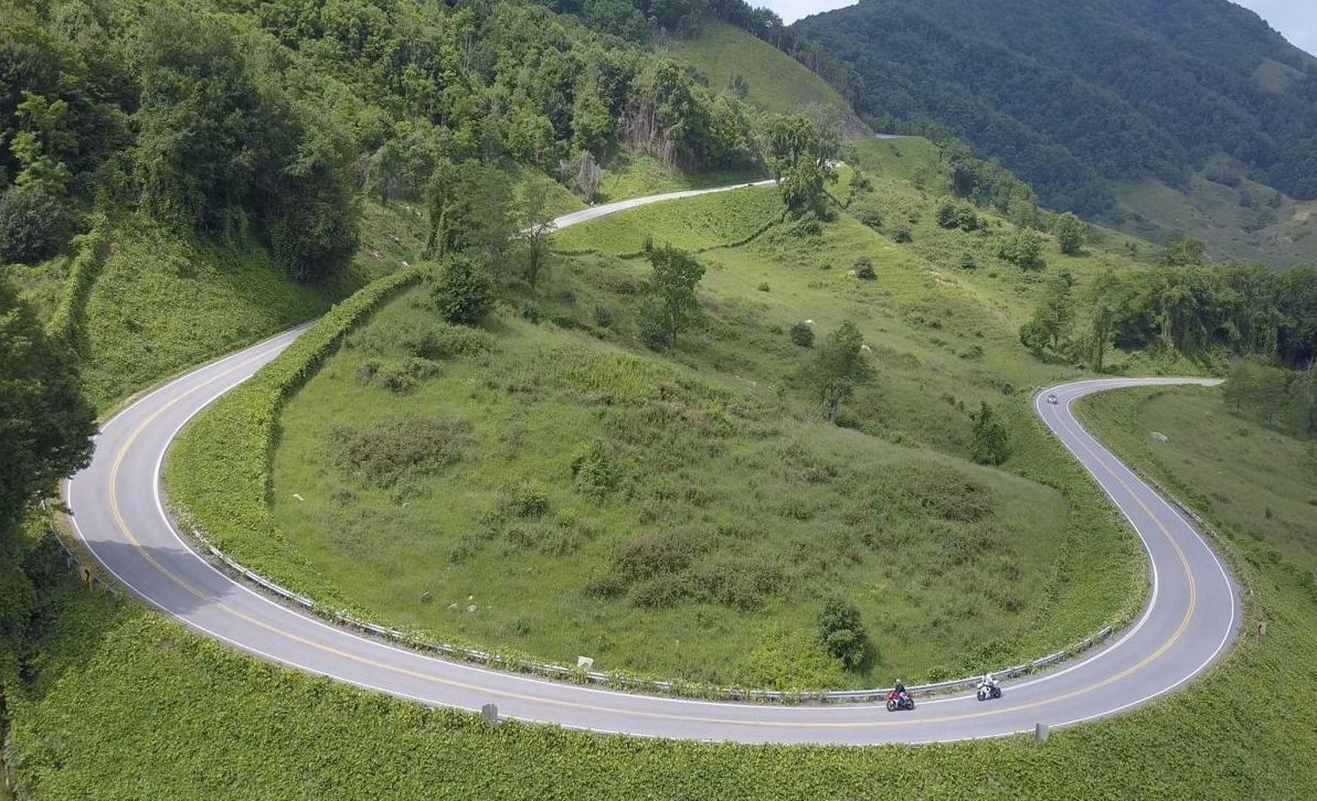 A sweeping series of curves follows the natural contours of the mountains.