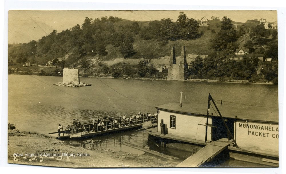Later Appalachian ferryman crossing with vehicles and passengers beside established ferry facilities in West Virginia.