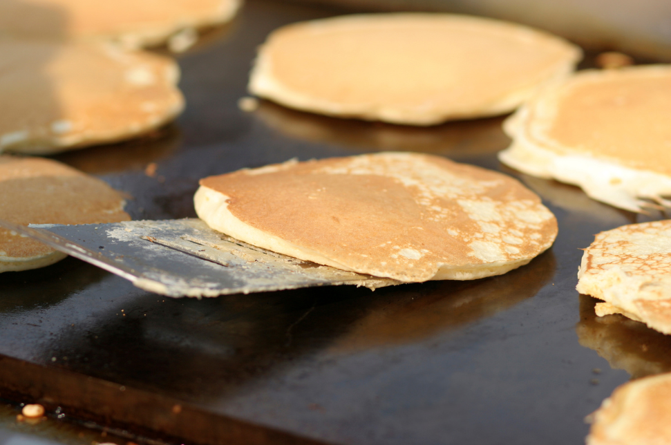 Pancakes cook on a griddle, a familiar sight at Appalachian fundraising meals such as Pancake Days.
